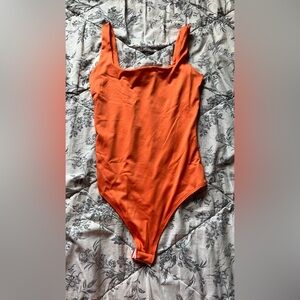Womens orange one piece bodysuit